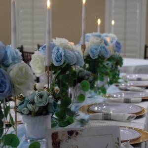 A captivating table setting adorned with delightful blue floral arrangements, creating an elegant and inviting atmosphere.